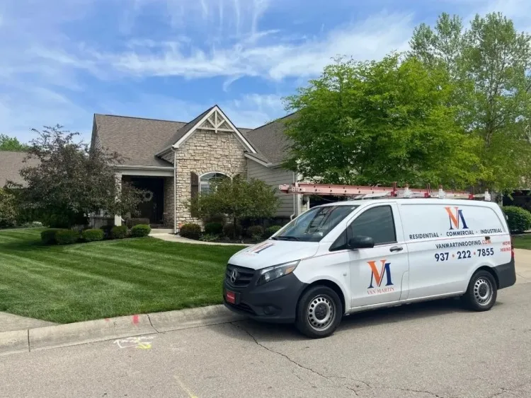 Van Martin Roofing van in front of a new roof installation in dayton ohio