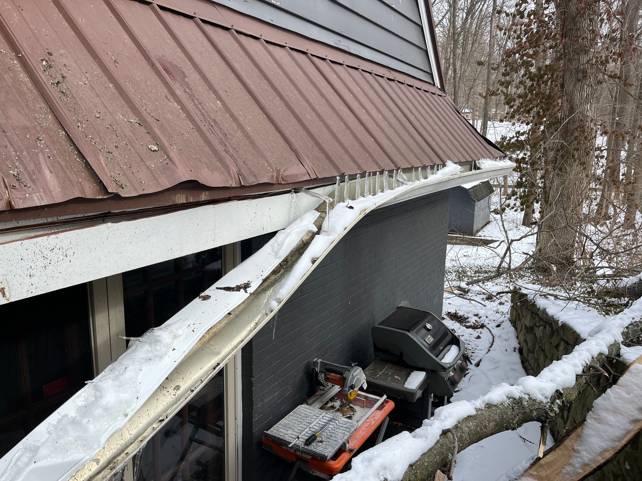 Snow and Ice Damage to Gutter on Home