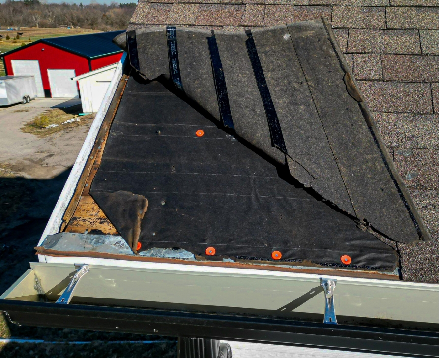 roof inspector checking shingles during a home inspection home inspector performing a roof inspection on a residential house comparison of home inspection and roof inspection on a house roof
